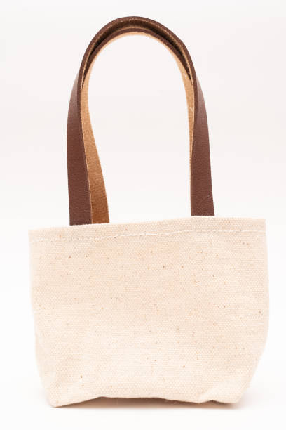istock small full canvas bag with ties, Reusable eco bag. Empty small cotton bag with string on white background. 1467197743