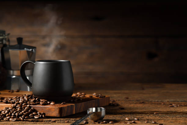 cup of coffee with smoke and coffee beans on old wooden background. moka pot and coffee cup. moka pot and coffee cup - bag coffee bean bean food imagens e fotografias de stock