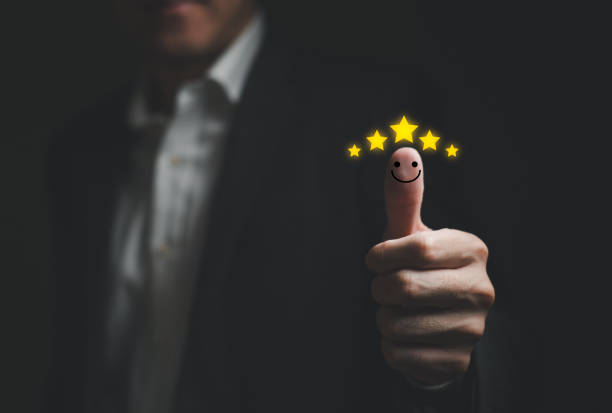 istock Selective focus at finger of business man while point finger to choose feedback on excellent customer service with five star score with smile. Service evaluation concept with futuristic icon 1467203765