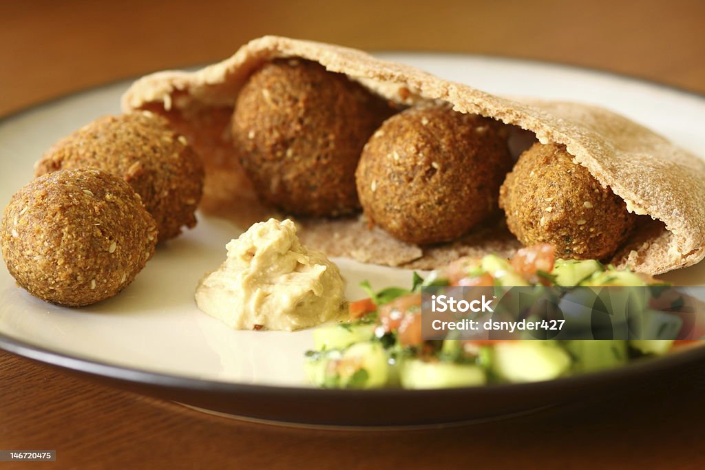 Falafil With Hummus Falafil in a pita with hummus and cucumber tomato salad Chick-Pea Stock Photo