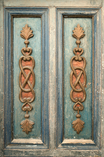 Old weathered wood board background, with carved ornate corners.