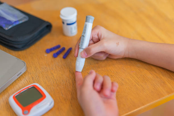 istock young girl using blood test kit at home while doing health check . home finger prick blood test . close up, diabetes concept, elderly health care, 1467207230