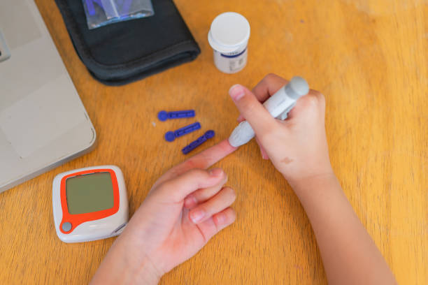 istock young girl using blood test kit at home while doing health check . home finger prick blood test . close up, diabetes concept, elderly health care, 1467207253