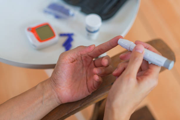 istock young woman using blood test kit at home while doing health check . home finger prick blood test . close up, diabetes concept, elderly health care, 1467207295