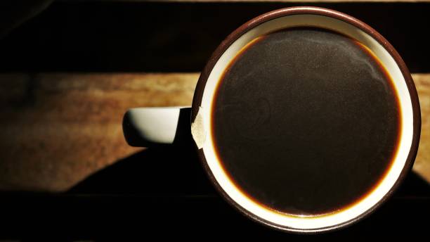 Coffee cup on a wooden table. Black coffee mug