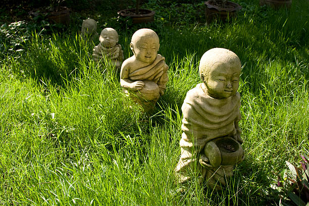 These are mass produced concrete Buddhas made in Thailand. This arrangement was made in someone's front yard.