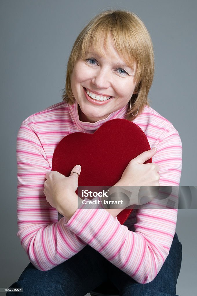 This is the greatest gift Woman showing appreciation for gift box of valentines day chocolates Hugging Self Stock Photo