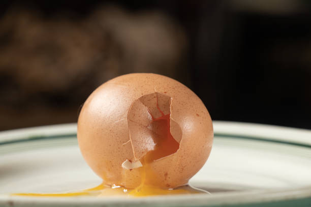 istock broken raw chicken egg brown lies on a plate close up 1467216749