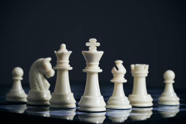 istock All suits white chess pieces on chess board. 1467216975