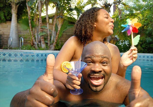 A couple enjoying a pool party in the summer stock photo