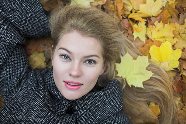 Beautiful young woman and autumn background with color leaves stock photo