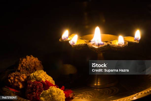 Panch Pradeep Or Five Headed Oil Lamp Burning With Glowing Flame With Marigold Flowers These Are Used In Hindu Puja Rituals Like Durga Saraswati Kali Laxmi Puja Shivaratri Holi Or Diwali Stock Photo - Download Image Now