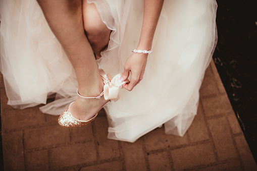 Bride tying her shoes
