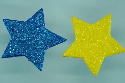 Blue glitter star on blue background. Christmas and New Year concept.