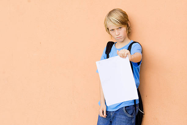 sad child showing bad exam results stock photo