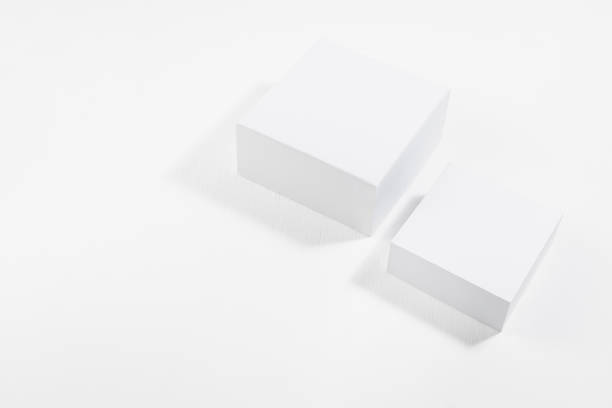 istock Elegant simple white stage - two square podiums in hard light with shadows on soft light white wood background, top view, template for presentation cosmetic products, goods, branding, design, showing. 1467229875