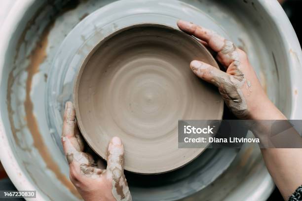 Top View Of Potters Wheel With Ceramic Plate And Hands Stock Photo - Download Image Now