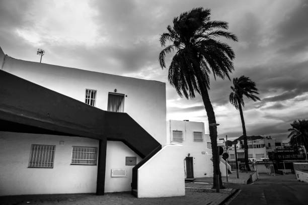 Las Negras, Almeria, Spain- November 17, 2022: Whitewashed houses and narrow street on a stormy day in Las Negras, Cabo de Gata, Almeria