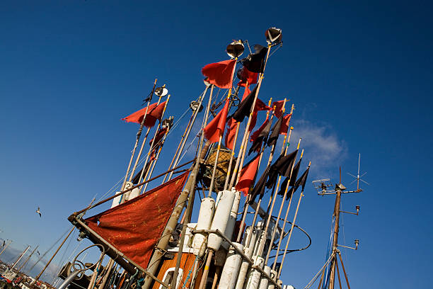 Little danish fishing boat with red and black flags