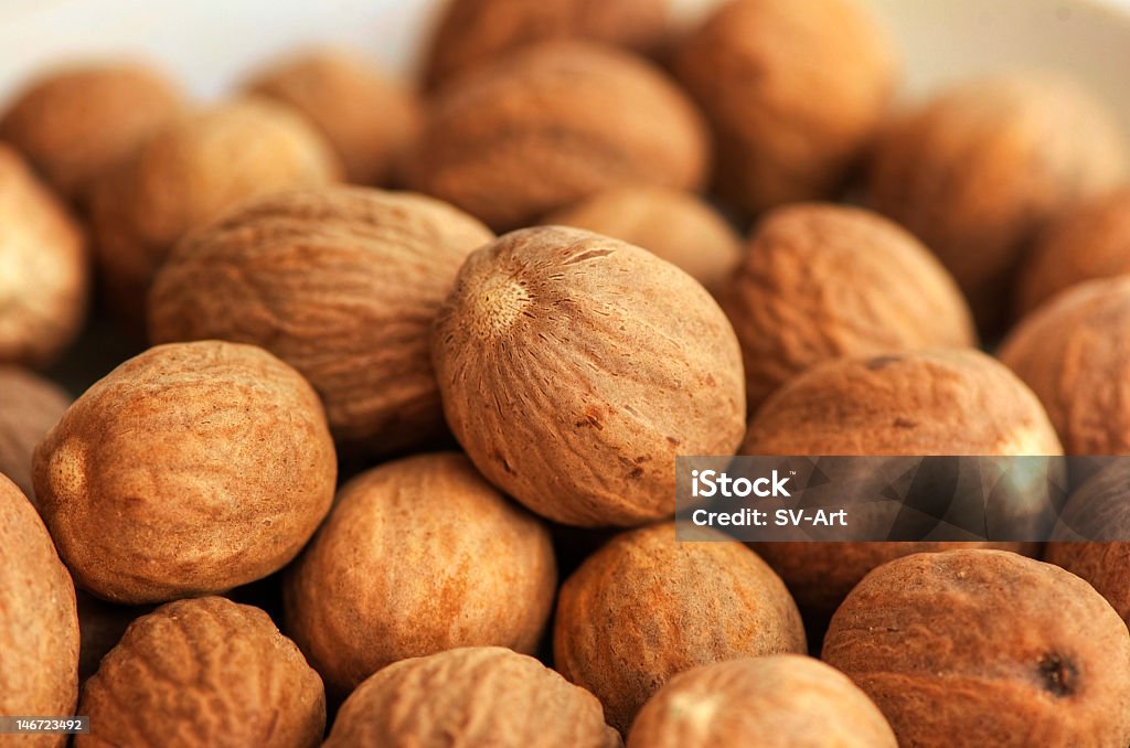 Closeup background image of nutmeg Heap of nutmegs Spice Stock Photo