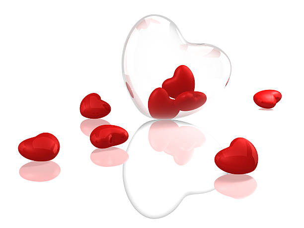 Glass heart with red hearts stock photo
