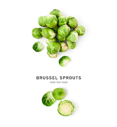 Fresh green brussel sprouts creative layout isolated on white background. Healthy eating and food concept. Garden vegetables composition. Flat lay, top view. Design element
