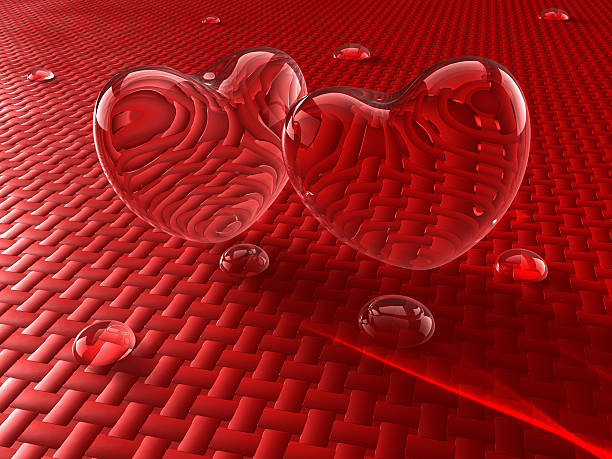 Two glass hearts with water drops stock photo