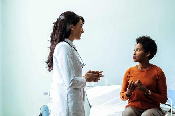 istock Medical professional talking to her patient in a checkup 1467240748