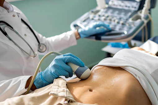 Doctor examining woman with ultrasound