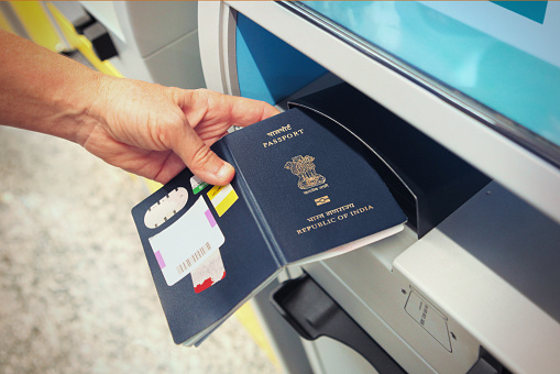 Passenger scanning indian passport at online check-in counter at the airport