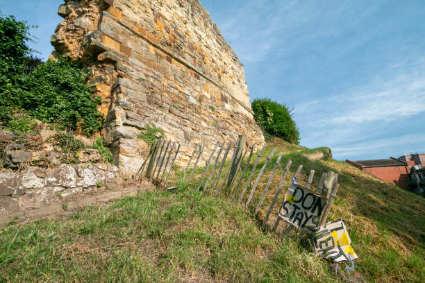 York, UK. January 5, 2024.  Cliffords Tower a famous York landmark sitting on a grass embankment. Steps lead up to the entrance and a sky with cloud is above.