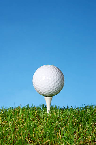 istock Golf ball on a white tee with lush grass. 146724709