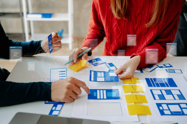 istock Close up view of UI developer team brainstorming on their project with laptop, smartphone and digital tablet. Creative digital development agency. 1467247583