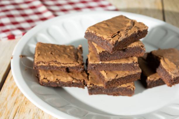 istock Delicious homemade chocolate brownie on a baking tray 1467250975