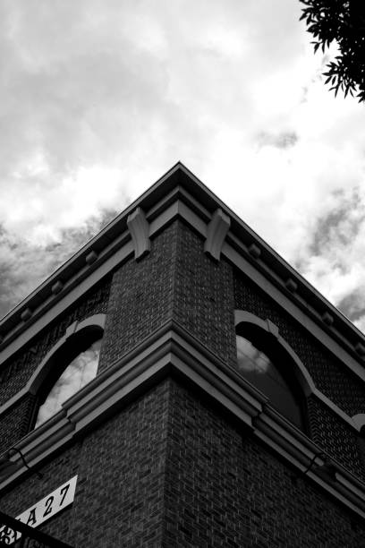 istock Vertical low angle grayscale of a angle of a building under the cloudy sky 1467251002