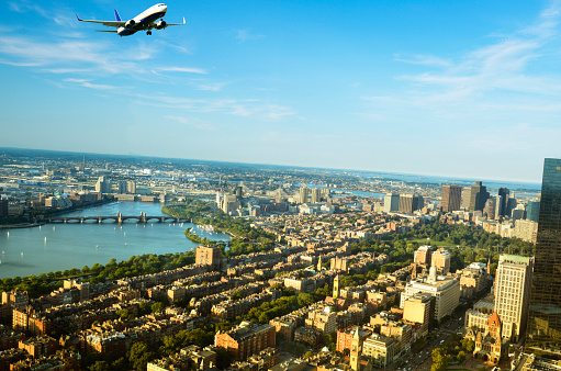 Airplane flying over Boston, Massachusetts, USA.
