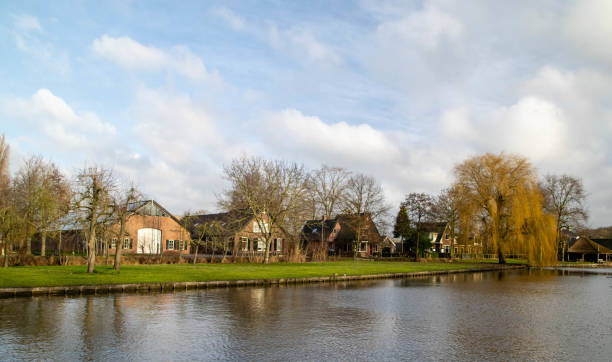 View of the river Oude Rijn near Woerden in the province of Utrecht with beautiful reflection of the clouds in the water stock photo