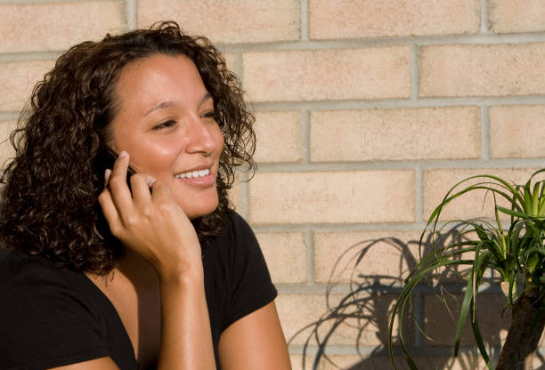 istock young woman talking on her cell phone, smiling 146725196