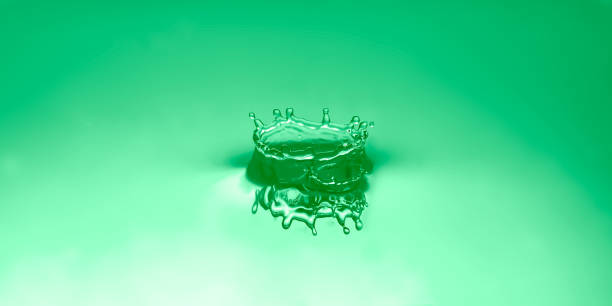 Water droplets, ripples on lime green calm background.