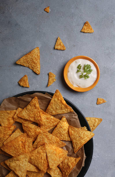 istock Vertical shot of chips in a plate with sauce on gray background 1467254465