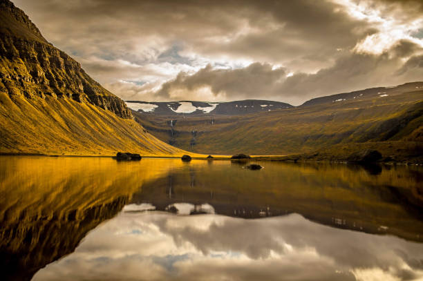 istock Photo of evening lake covered with mountains 1467258986