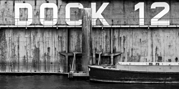 dock 12 - large commercial dry dock with small boat moored in front