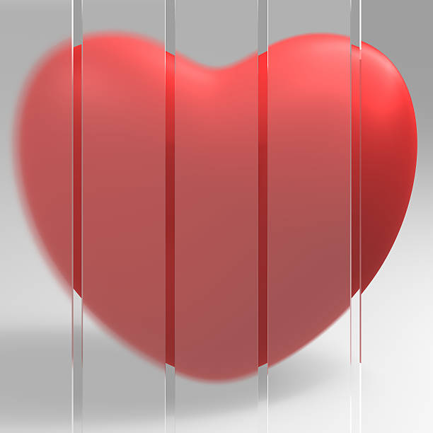 Red heart behind the glass wall stock photo