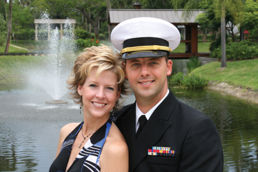 A U.S. Naval Officer smiles with a beautiful woman.