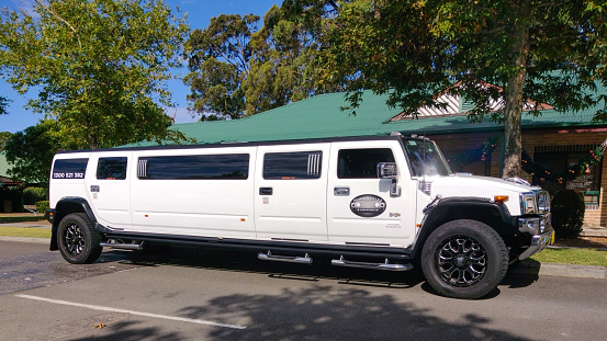 Luxury Stretch Hummer Limousine primarily white in colour, parked outside a community hall in South Sydney, NSW Australia