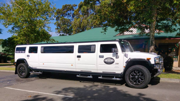 Luxury Stretch Hummer Limousine primarily white in colour, parked outside a community hall in South Sydney, NSW Australia stock photo