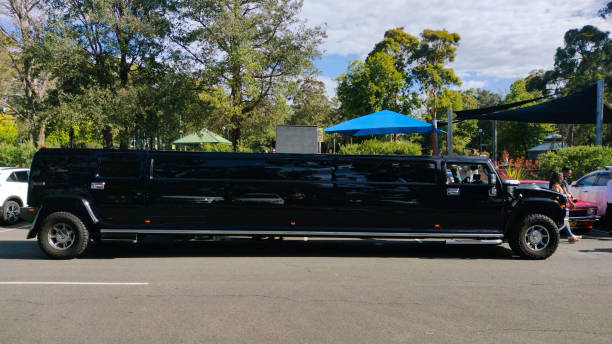 Luxury Stretch Hummer Limousine primarily black in colour, parked outside a community park in South Sydney, NSW Australia stock photo