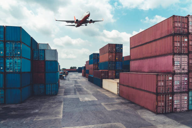 istock Cargo container for overseas shipping in shipyard with airplane in the sky . Logistics supply chain management and international goods export concept . 1467266110