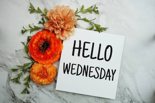 Hello Wednesday text with orange flower bouquet on marble background Hello Wednesday text with orange flower bouquet on marble background wednesday morning stock pictures, royalty-free photos & images
