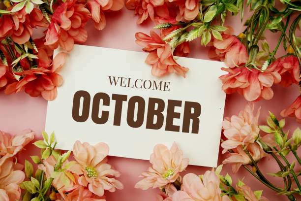 istock Welcome October typography text with flowers frame on pink background 1467268097